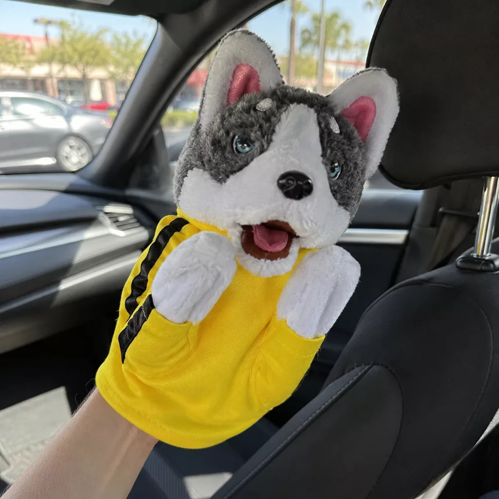 The husky puppet riding along in the passenger seat of a car